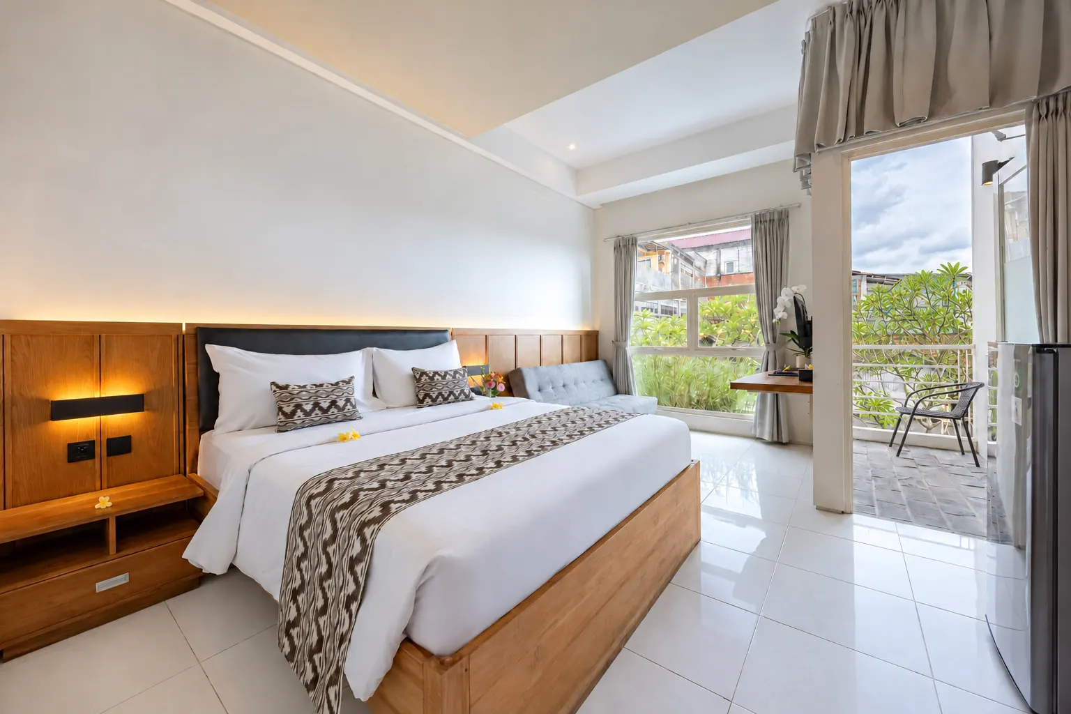 Executive Suite at Bali True Living in Denpasar, Bali, with tall windows and balcony access