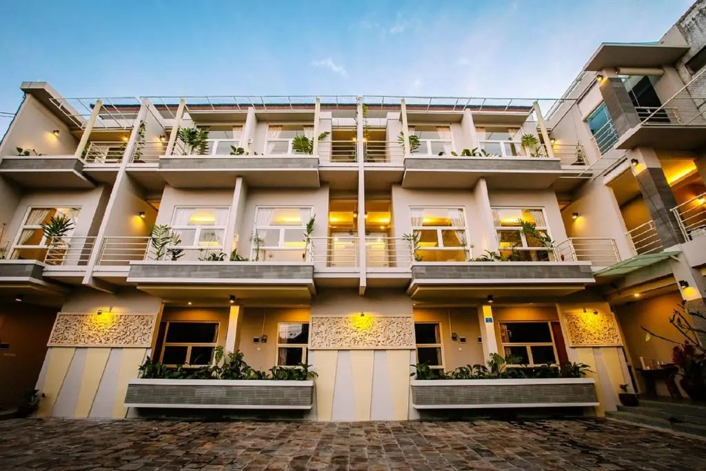 Bali True Living apartment building illuminated at dusk