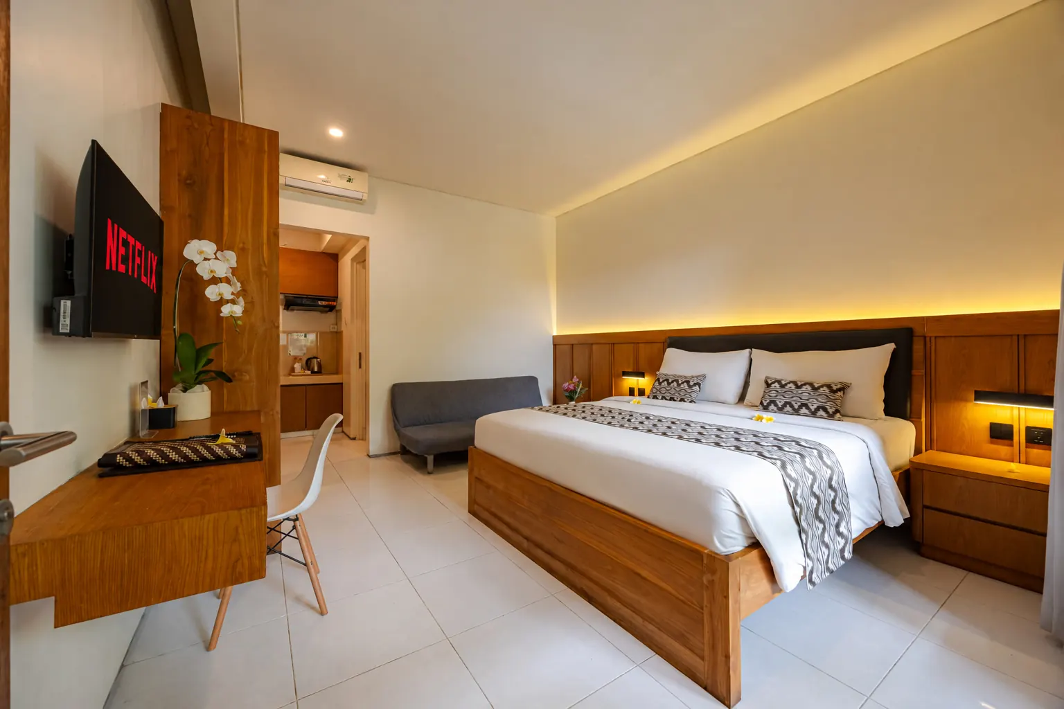 Premier Suite at Bali True Living in Denpasar, Bali, with teak furnishings and a king-size bed